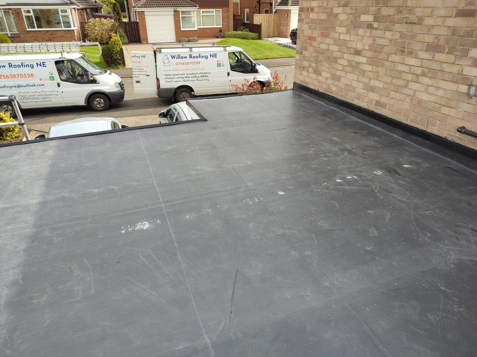 finished EPDM flat roof, branded van in background