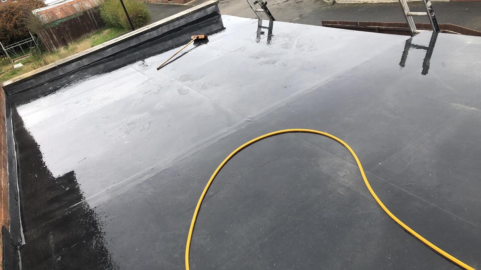 glossy black EPDM flat roof, freshly finished