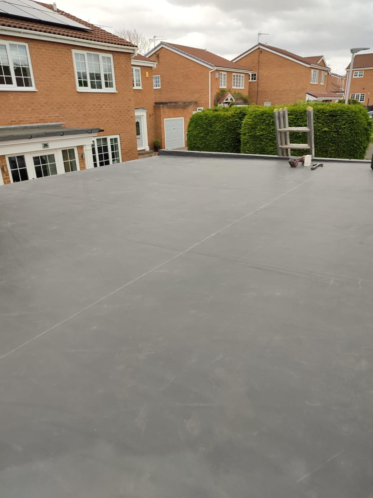 large grey fibreglass roof over garage block — recent Willow Roofing work