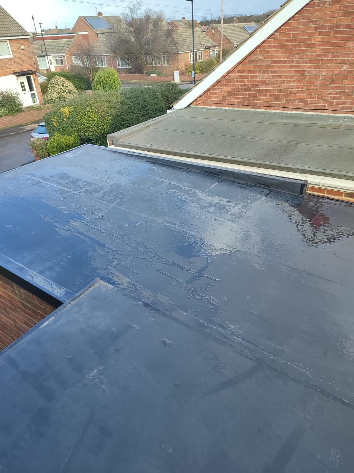 EPDM flat roof below tiled gable, estate view