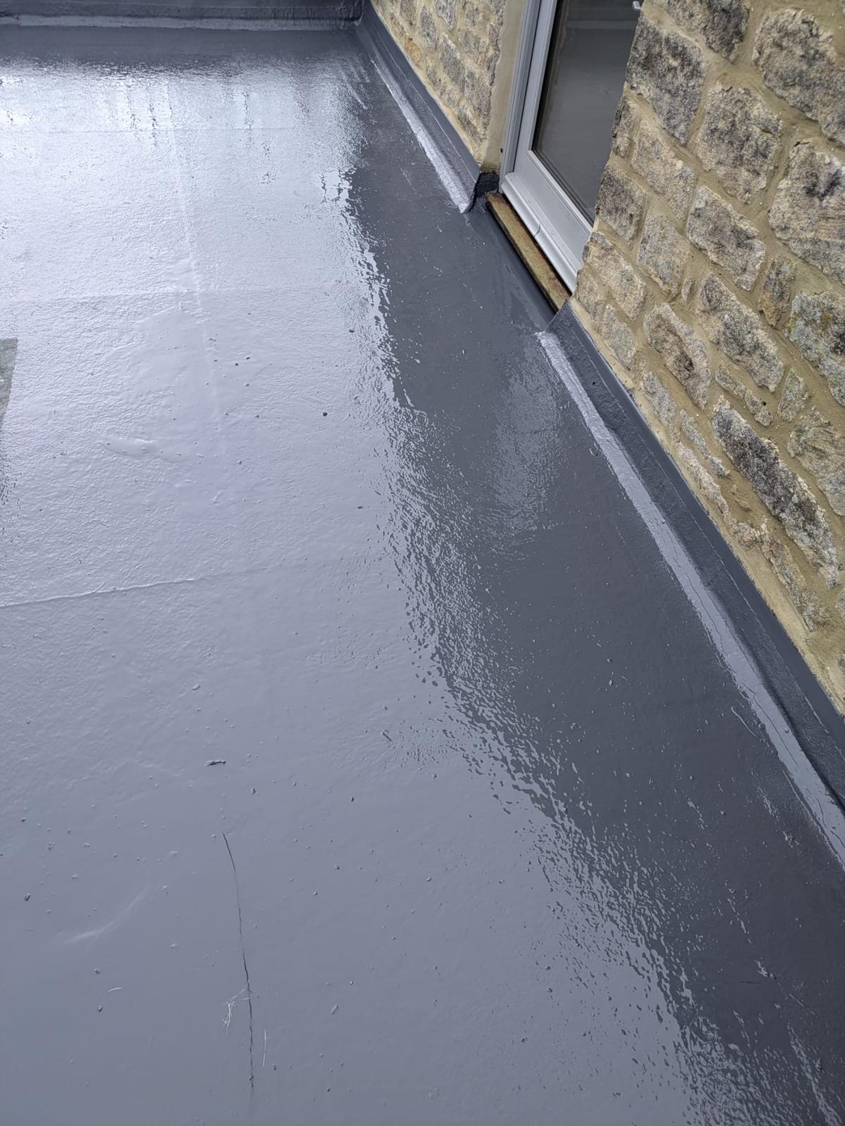 fibreglass flat roof dressed up to a stone wall and door threshold
