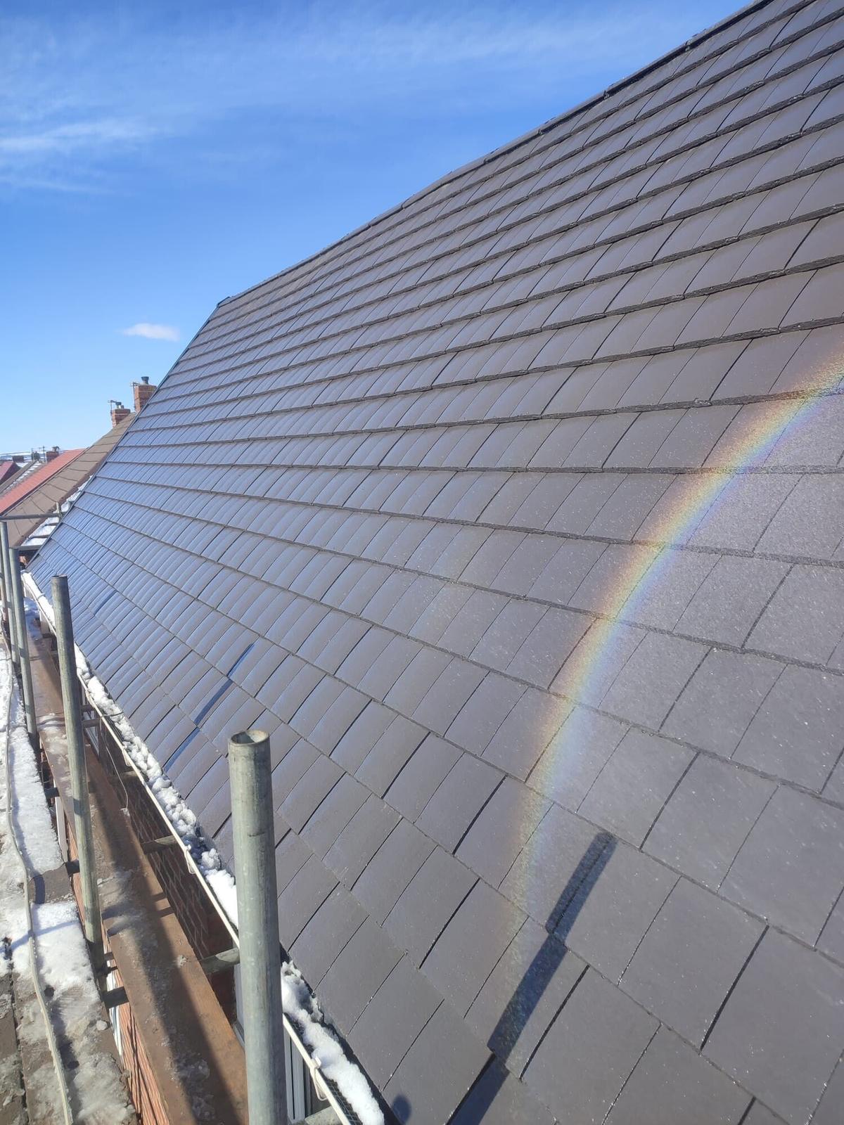 new slate roof with rainbow overhead, striking