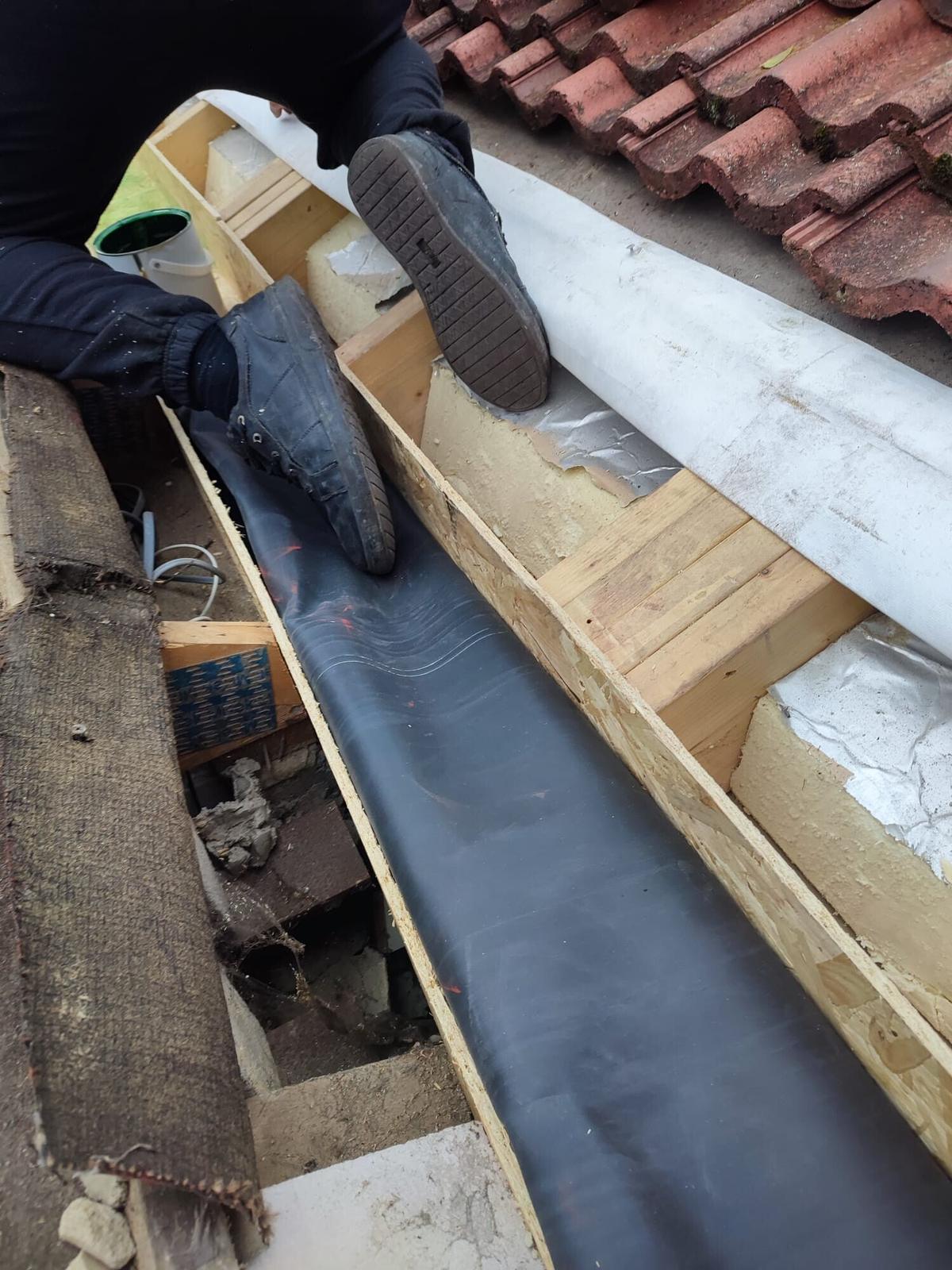 hands dressing lead over tiles, close detail