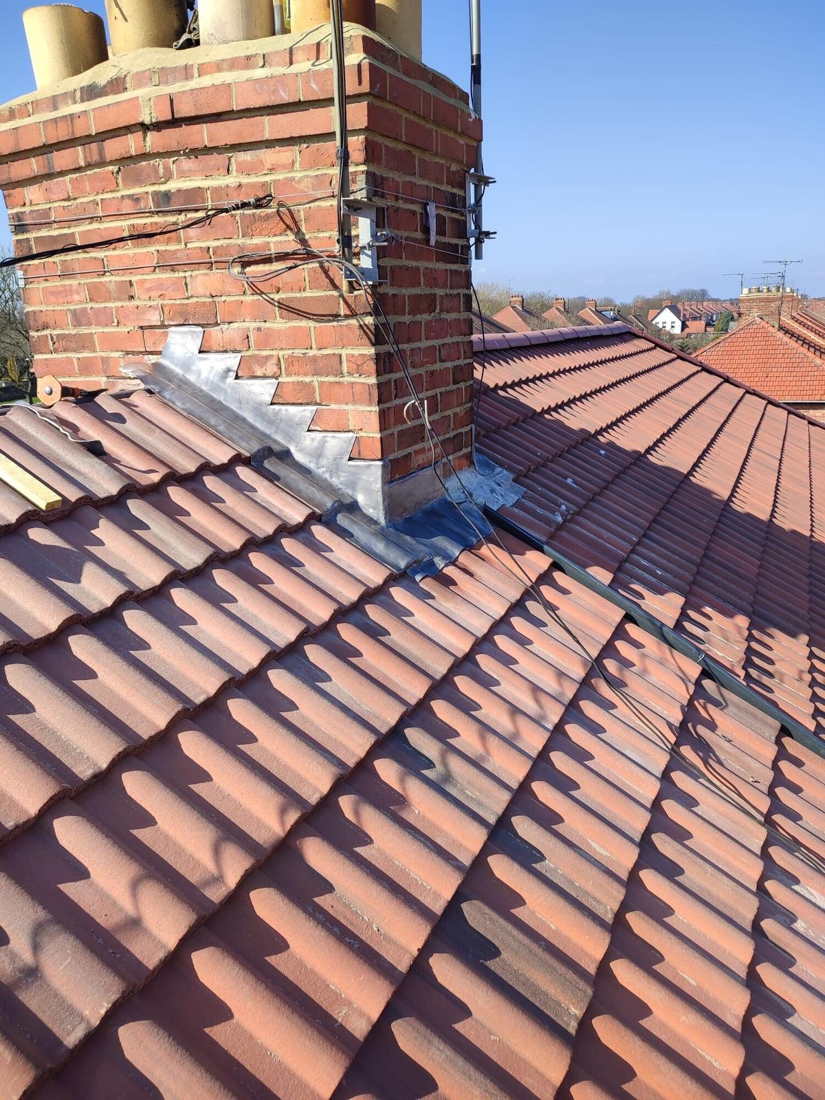 sunny red pantile roof, chimney with new flashing