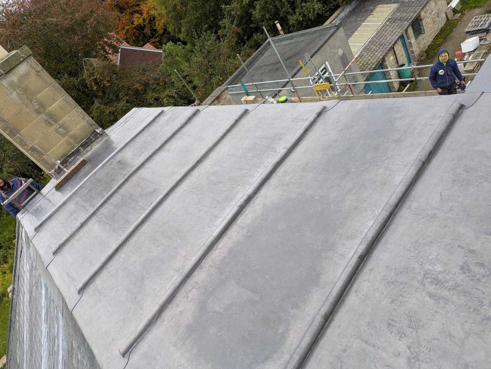 hand-dressed lead bays and rolls meeting the chimney, wide view