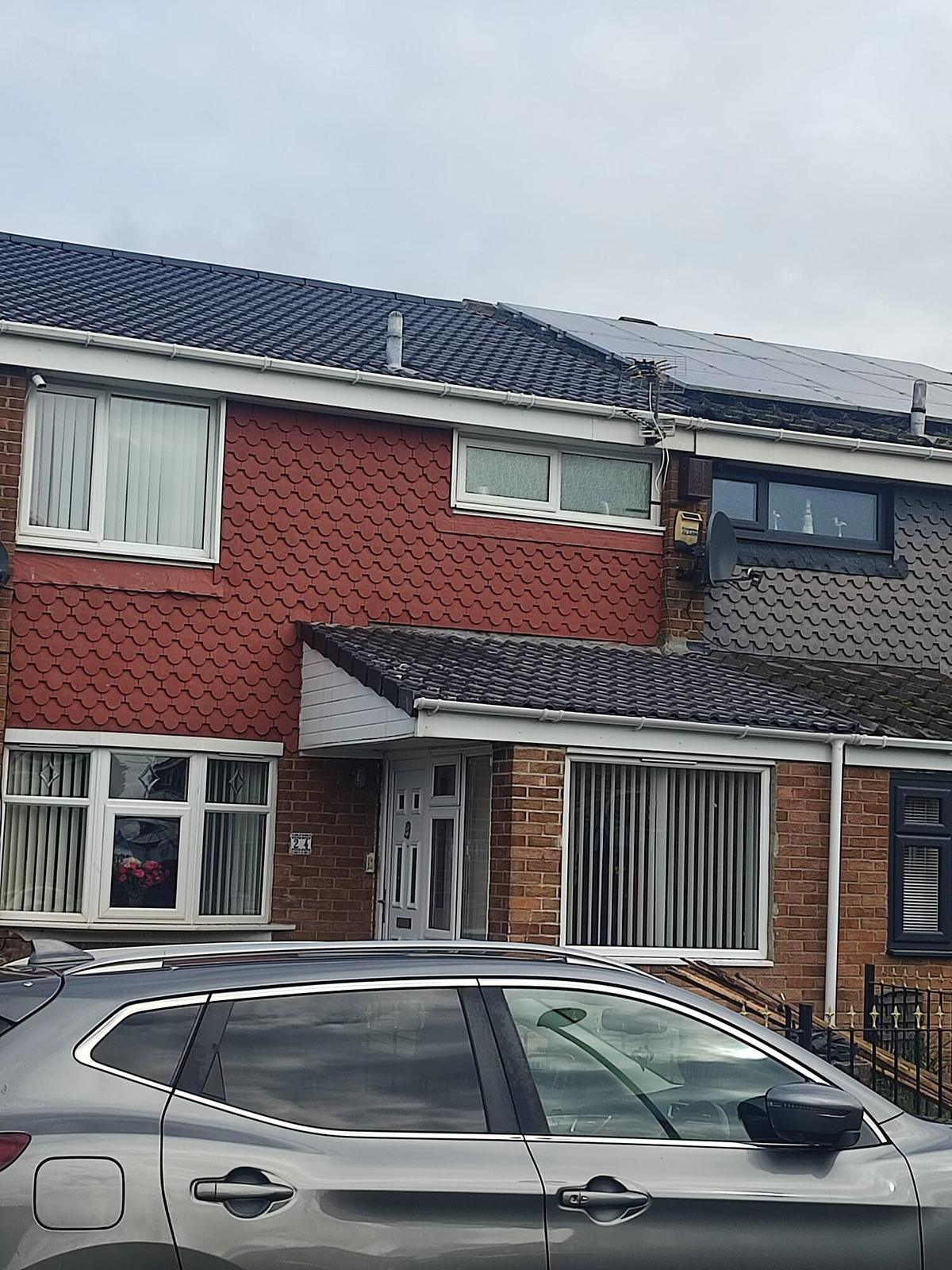 semi with new grey tiled roof, street front
