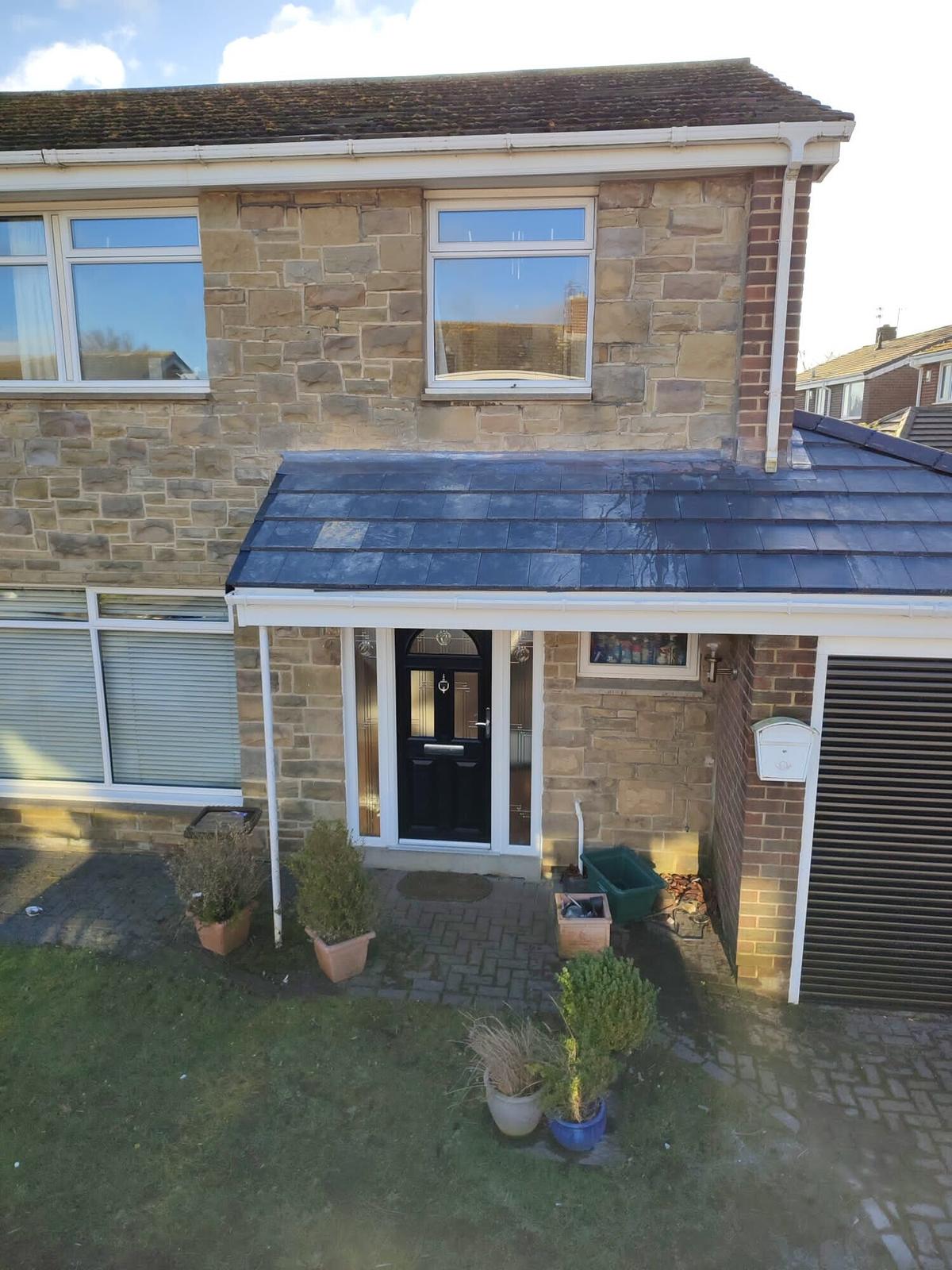 stone house with new slate extension roof