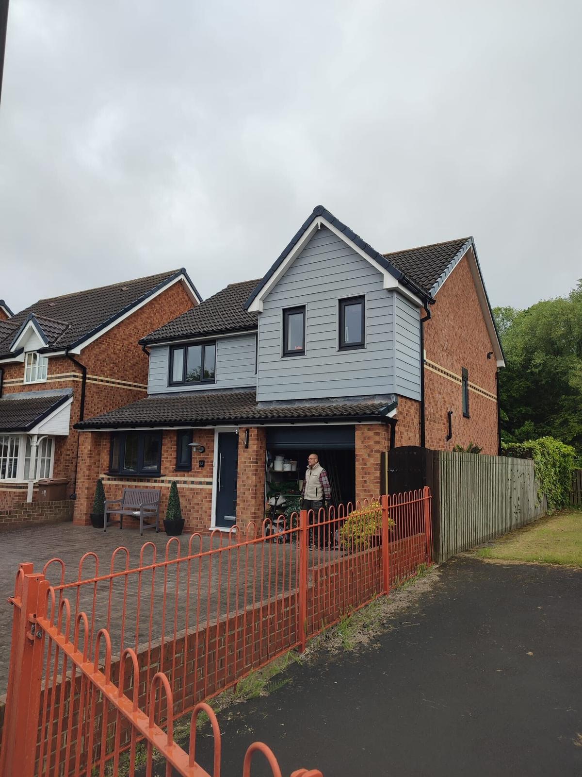 modern detached with new dark roof, red fence — recent Willow Roofing work