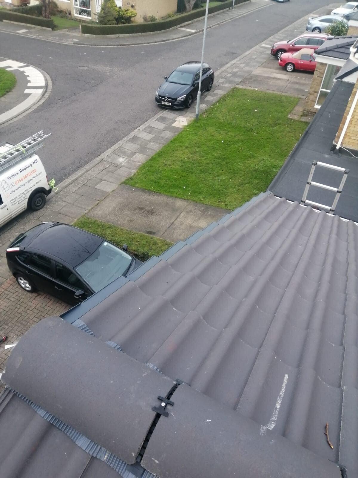 new grey concrete tile roof from ridge, street below — recent Willow Roofing work