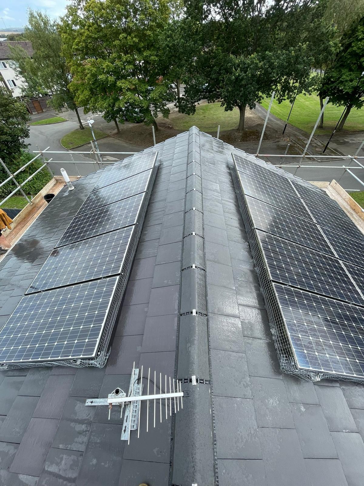 new grey tiled roof with solar panels either side of the ridge, Washington