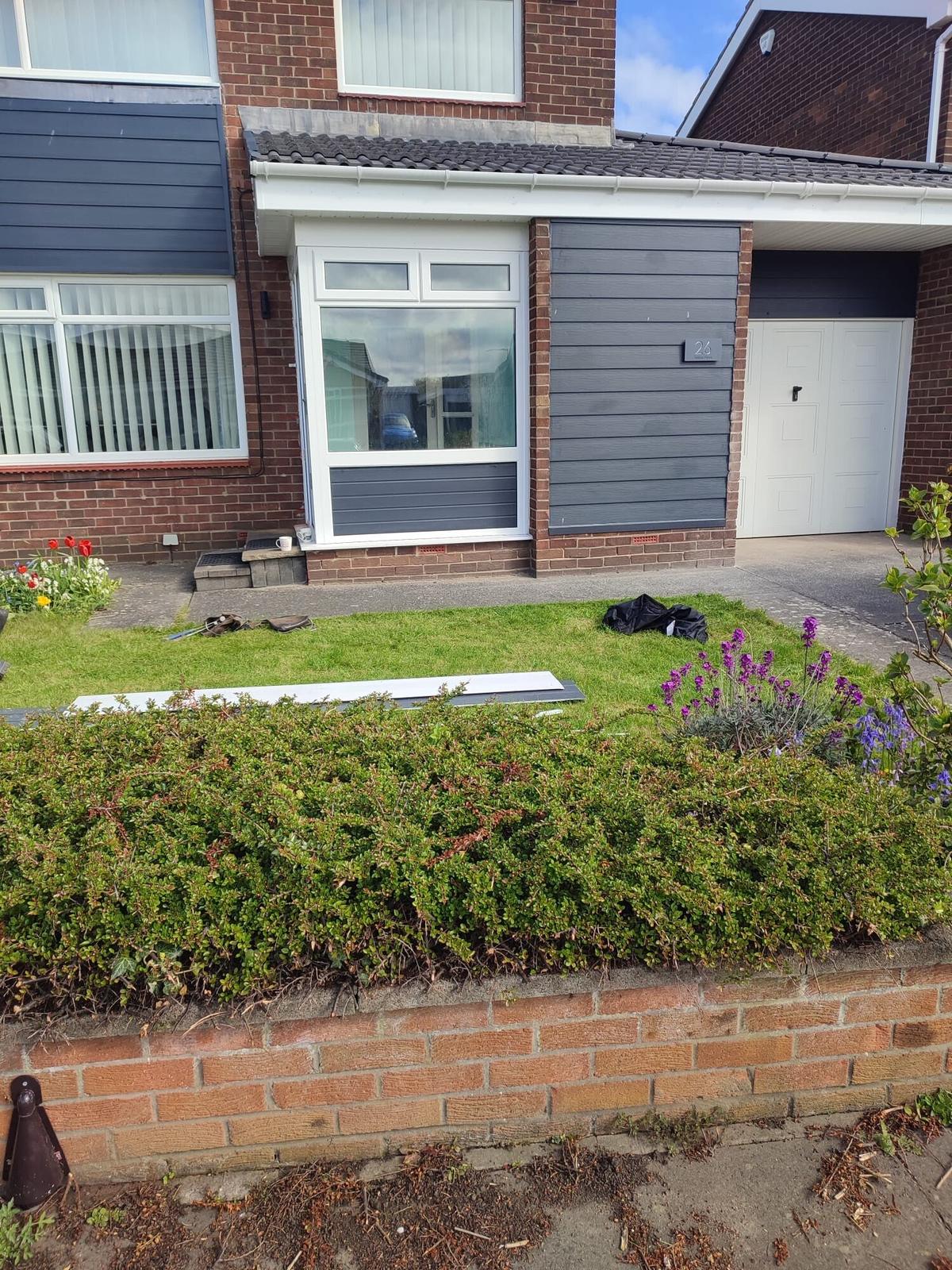 bungalow with new grey gable cladding, hedge front — recent Willow Roofing work