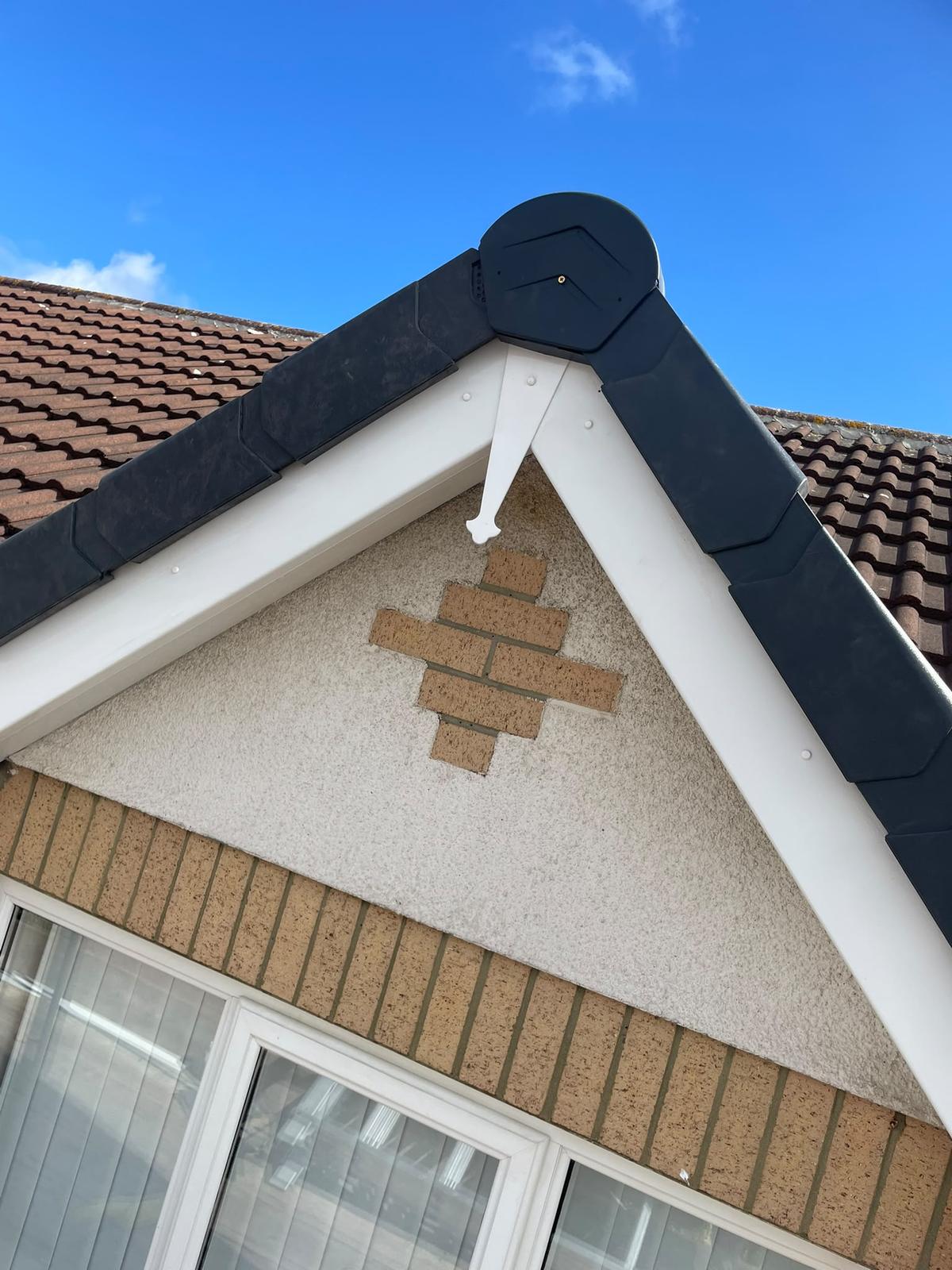 gable apex with new dry verge cap and white fascia boards, Cramlington