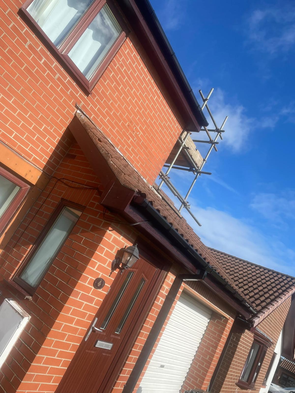red-brick house with new rosewood roofline and gutters, Killingworth